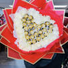 Beautiful bouquet with a heart made of chocolates and roses around it
Roses