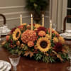 This centerpiece captures the warm, inviting spirit of an autumn feast, rendered
