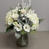 Beautiful combination of white seasonal flowers with silver accents in a silver