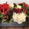 A lovely Christmas centerpiece! 
The arrangement is in a rectangular wooden box
