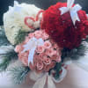 Christmas bulbs made of roses and carnations in a gift box 