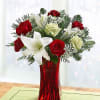 Our enchanting bouquet of red roses, white lilies, alstroemeria and evergreens delivers