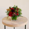 Brighten your holiday season with this petite red and maroon arrangement, overflowing