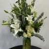 This classic vase of white flowers is an always-welcome gift for the