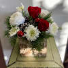 Roses. Glorious ranunculus. Holiday greenery and trim. Just beautiful!