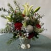 A festive collection of colorful and fragrant flowers with seasonal greenery and