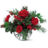 An elegant rose bowl, filled with festive flowers and foliage, makes this