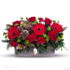 Assorted seasonal red and green flowers with pine cones and assorted Christmas