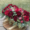 Deep red hues and winter greenery adorned with some mini ornaments to