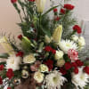 Lilies,mini carnations, mums, mixed Christmas greens, spray roses, with bulbs, and berry