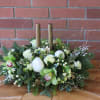 Gorgeous centerpiece with lush white peonies, green orchids, roses and evergreens accented