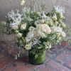 A beautiful tall arrangement of the loveliest textured white flowers. We will