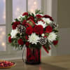 Evoking the warmth and joy of a cozy Christmas, this bouquet delivers