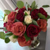 "Crimson Dawn" is an enchanting floral arrangement that embodies the vitality of