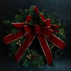 A 24&quot; mixed pine wreath decorated with a lux velvet red ribbon