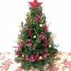 Bright someone&#039;s day with this festively decorated Boxwood tree. Decorations and bows