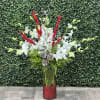 This classic arrangement is designed with white dendrobium orchids, Christmas greens and