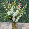 This arrangement comes designed with white dendrobium orchids, cedar pine, curly willow