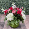 This fun and festive arrangement comes designed in a bubble bowl with