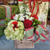 This arrangement includes the colors of the season, red, white, and green!