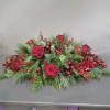 This long and low design is filled with luscious red roses, berries