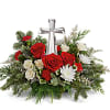 The crystal cross is nestled elegantly among red and white blooms, this