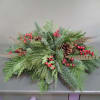 This natural, classic centerpiece is filled with evergreens, berries and pine cones.