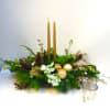 This long low candle centerpiece highlights golds and greens of the season.
