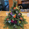 A hand made holiday tree with colorful floral. Colors may vary