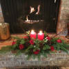 Designed with the freshest winter greens, red roses, dogwood branches and accented