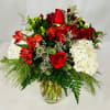 Splendid arrangement of roses, white hydrangeas, red alstroemeria and other flowers including