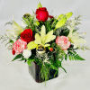 Blooming with Christmas memories, this holiday flower arrangement is ready to spread