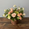 A beautiful arrangement with whites, greens and peaches that anyone would love.