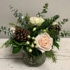 Ivory and white blooms with a mixture of Christmas greens and wintery