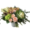 Orange cymbidium orchids, kale, white calla lily, green hydrangea, blue thistle, peach