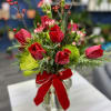 Brighten your holiday season with this stunning arrangement of red tulips in