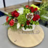This charming holiday arrangement features roses and dianthus in vibrant festive colors