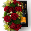 A showstopping gift box overflowing with lush Christmas florals, finished with a