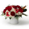 A show stopping gift box overflowing with lush Christmas florals, finished with
