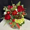 A cheerful seasonal garden mix in red, white and green accented with