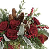 Designer&#039;s choice of seasonal flowers in a Christmas container. 