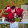 Lovely bouquet of roses, hydrangea and orchids and holiday ornaments in white