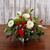 Rounded classic style holiday centerpiece with a festive mix of premium flowers