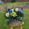 Our rustic whitewashed box overflows with seasonal flowers and fragrant greens. Holiday