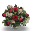 A lush and elegant arrangement featuring vibrant red roses nestled among fresh