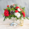 Classic rounded holiday centerpiece filled with  mums, carnatons, pine cones and