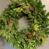 Locally sourced holiday wreath with a variety of fresh evergreens. Upgrade to