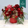 This beautiful arrangement includes a mix of vibrant red roses, hydrangeas, and