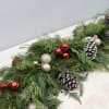Garland for all! Fresh greens decorated with pinecones and ornaments for your