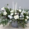 This mix of white florals, seasonal greenery, and holiday accents is simple